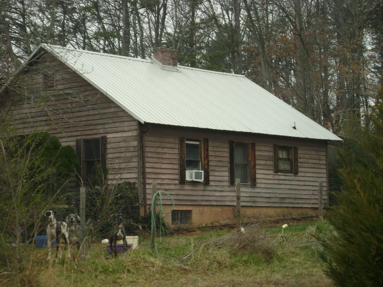 White metal roof on an old wood sided farmhouse, from a Metal Roof Installation job in Roselle Park